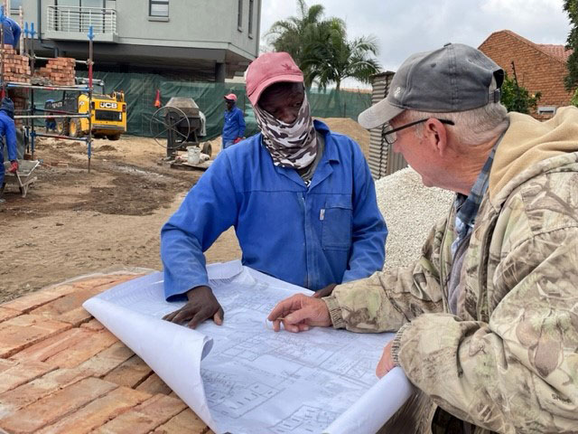 Reviewing plans on site with the team